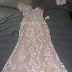 Strapless, white lacey dress with nude lining. Floor length from Lulu’s